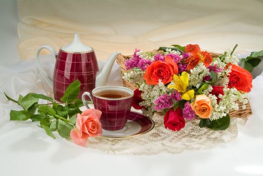 Still life with bouquet of flowers and accessories on a studio background