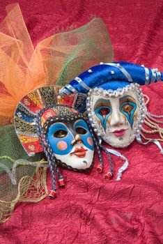 Venetian carnival masks on a fabric studio background