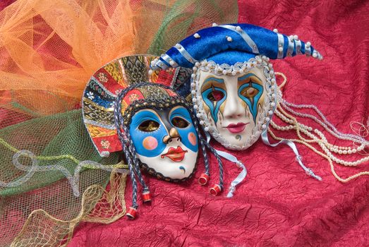 Venetian carnival masks on a fabric studio background