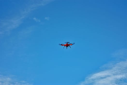 orange drone on the blue sky.