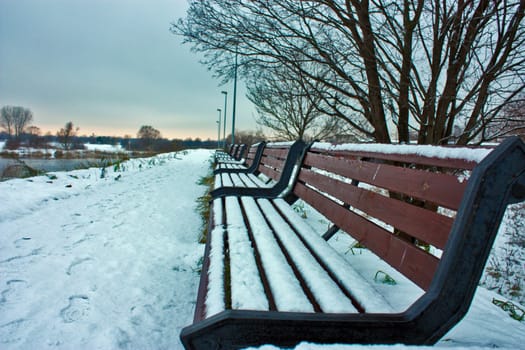 Winter view on the bench with snow.