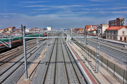 Heavy industry. Top of view on cargo railway station. Industrial scene with railroad, city buildings and blue sky.