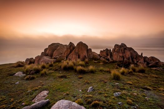 Tors and boulders at a small lake in Snowy High Plains.  The flood plain with more water than usual had the usual road access blocked, so this essentially was where the road stopped.  Here the foggy sunrise gives the scene a mystical drama