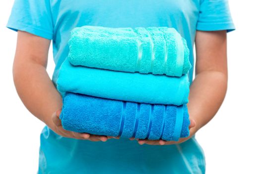 stack of ironed terry towels in male hands close-up