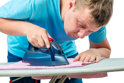 very focused man ironed a terry towel, the portrait is isolated