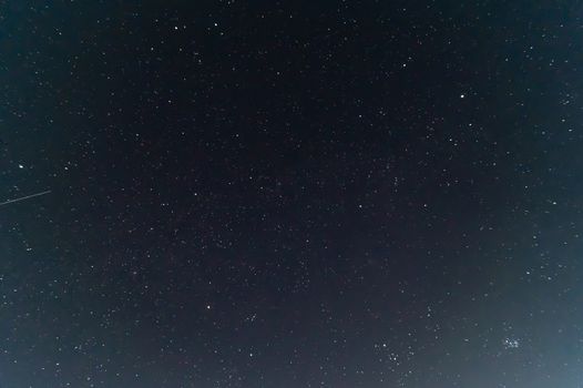 Underexposed night sky low light photo. A lot of stars and constellations on dark sky. Stock photo of deep sky.