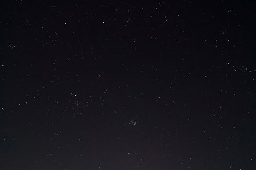 Underexposed night sky low light photo. A lot of stars and constellations on dark sky. Stock photo of deep sky.