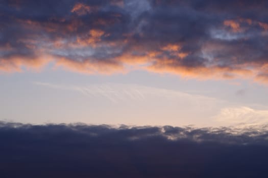 Red evening sunset above the lake or river. Purple and blue clouds and falling sun