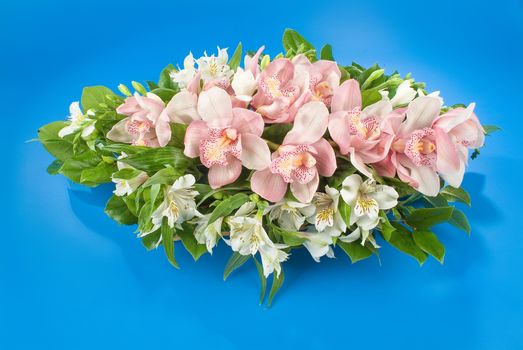 Still life with bouquet of flowers and accessories on a studio background