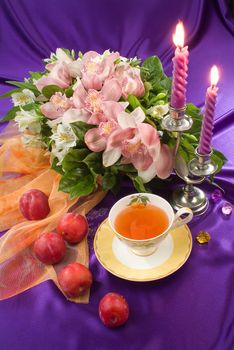 Still life with bouquet of flowers and accessories on a studio background