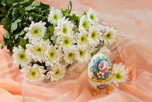 Still life with bouquet of flowers and accessories on a studio background