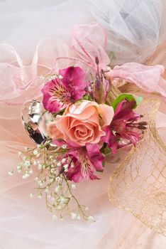 Still life with bouquet of flowers and accessories on a studio background