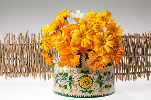 Still life with bouquet of flowers and accessories on a studio background