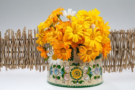 Still life with bouquet of flowers and accessories on a studio background