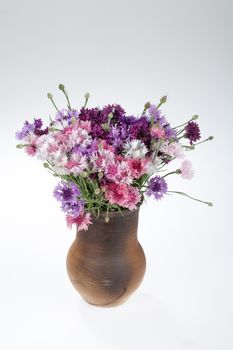 Still life with bouquet of flowers and accessories on a studio background