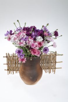 Still life with bouquet of flowers and accessories on a studio background