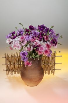 Still life with bouquet of flowers and accessories on a studio background