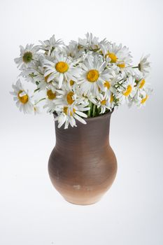 Still life with bouquet of flowers and accessories on a studio background