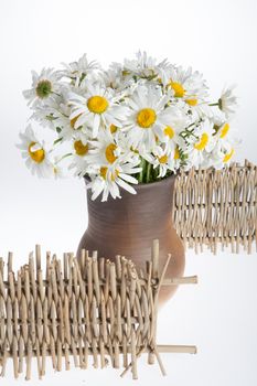 Still life with bouquet of flowers and accessories on a studio background