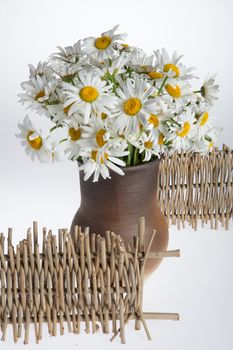 Still life with bouquet of flowers and accessories on a studio background