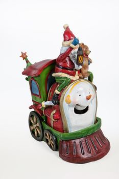 Statuette of Santa Klaus on old fashioned locomotive on isolated background