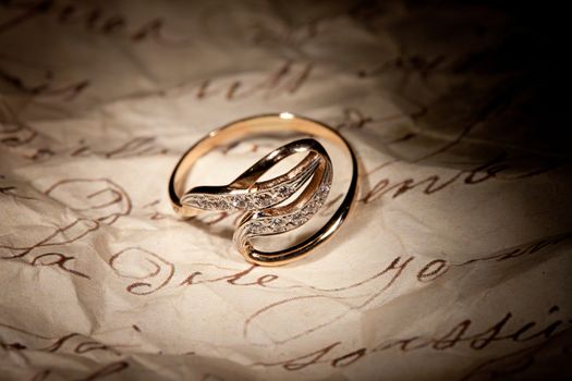 Golden ring with gem on an old manuscript