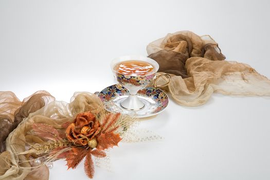 Still life with bouquet of flowers and accessories on a studio background
