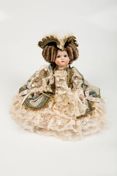 Doll dressed in vintage style on a studio background