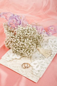 Still life with bouquet of flowers and accessories on a studio background