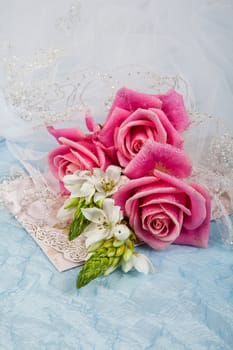Still life with bouquet of flowers and accessories on a studio background