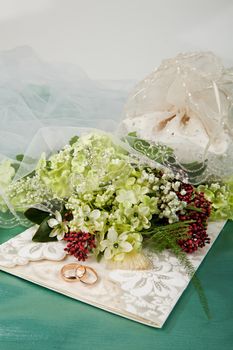 Still life with bouquet of flowers and accessories on a studio background