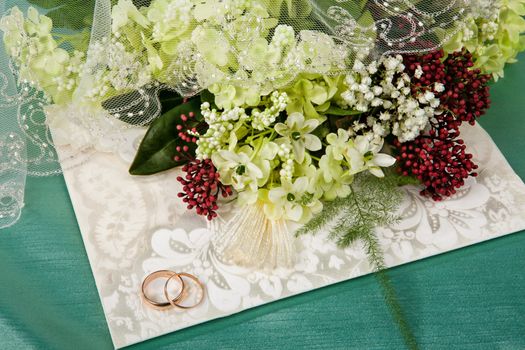 Still life with bouquet of flowers and accessories on a studio background