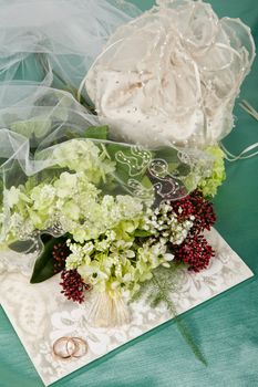 Still life with bouquet of flowers and accessories on a studio background