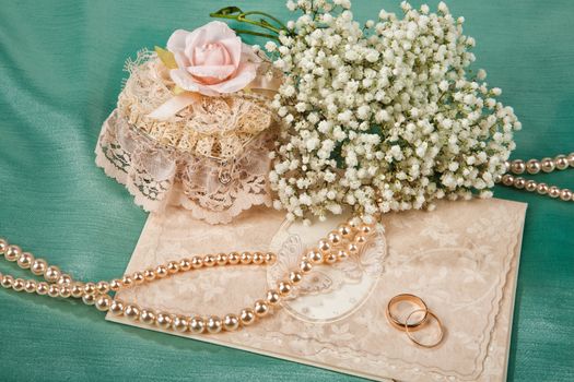 Still life with bouquet of flowers and accessories on a studio background