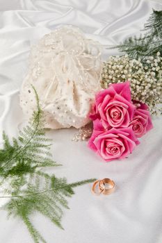 Still life with bouquet of flowers and accessories on a studio background