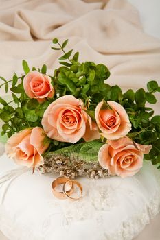 Still life with bouquet of flowers and accessories on a studio background