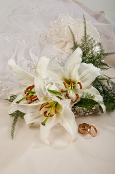Still life with bouquet of flowers and accessories on a studio background