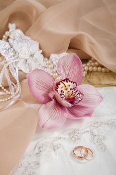 Still life with bouquet of flowers and accessories on a studio background