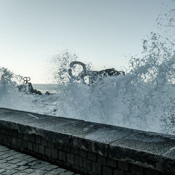Sea waves splashing near the Peine de los Vientos sculpture