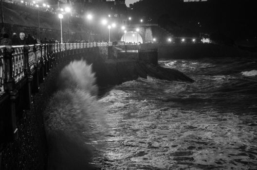 Splashing waves caught in movement at night in San Sebastian