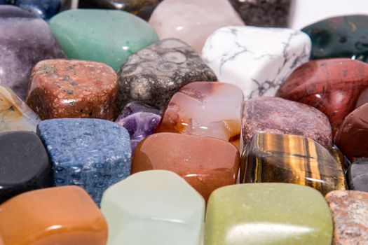 Collection of many kinds of polished gemstones originating from all continents