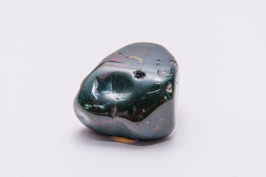 Indian Achat deep green gemstone with red and yellow structures all over it