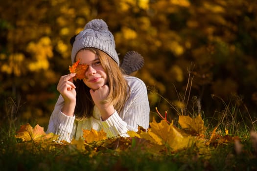Portrait of pretty nice teenage girl in autumn park , background with copy space for text