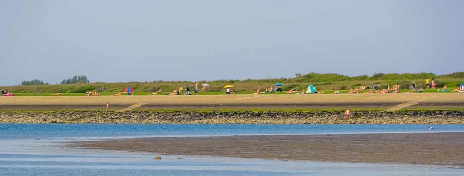 People recreating naked at the nudist beach of Tholen, Bergse diepsluis, Oosterschelde, The Netherlands