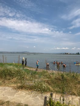 Pomorie, Bulgaria - July 05, 2019: People Visit Lake Pomorie. It Is An Natural Lagoon Which Is Also The Northernmost Lake Of The Burgas Lake Group.
