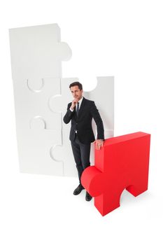 Business man with puzzle pieces thinking about problem solution isolated on white background
