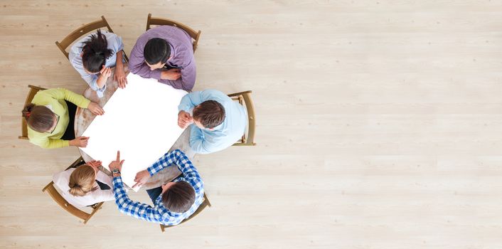 Hipster business teamwork brainstorming planning meeting concept, people team sitting around the table with white paper and pointing, copy space for content