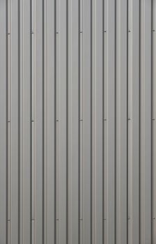 Unpainted aluminum grey corrugated goffered metal wall texture