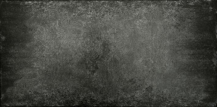 Grunge dark grey uneven stone texture background with cracks and stains