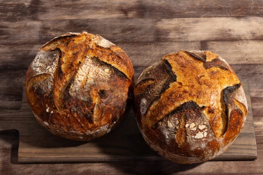 Freshly baked artisan sourdough bread loaves on a wooden board.